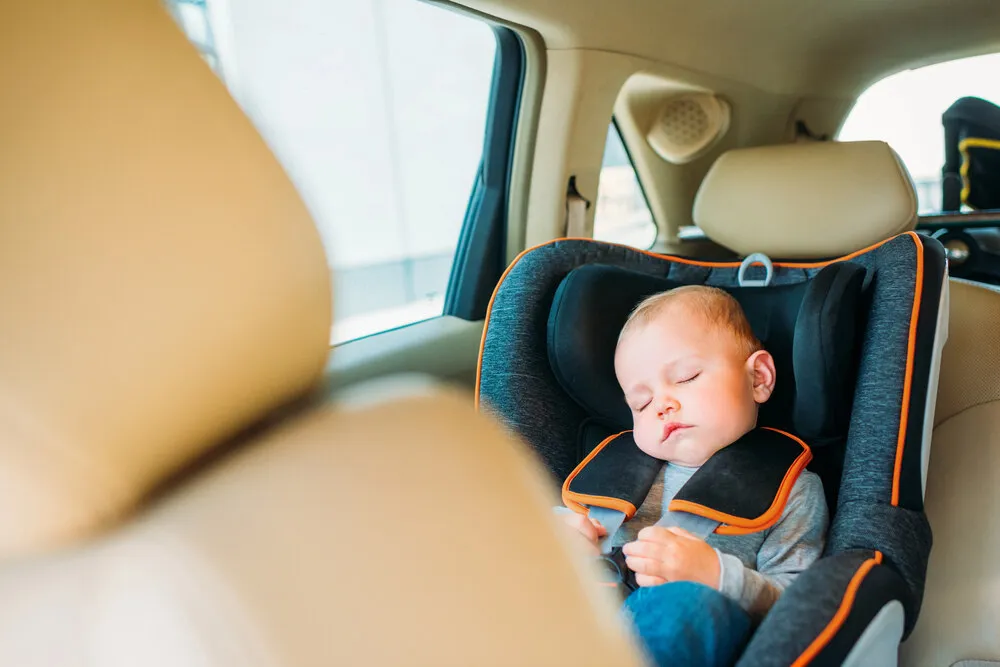 Illustration Of A Baby Sleeping In A Safety Seat In A Car