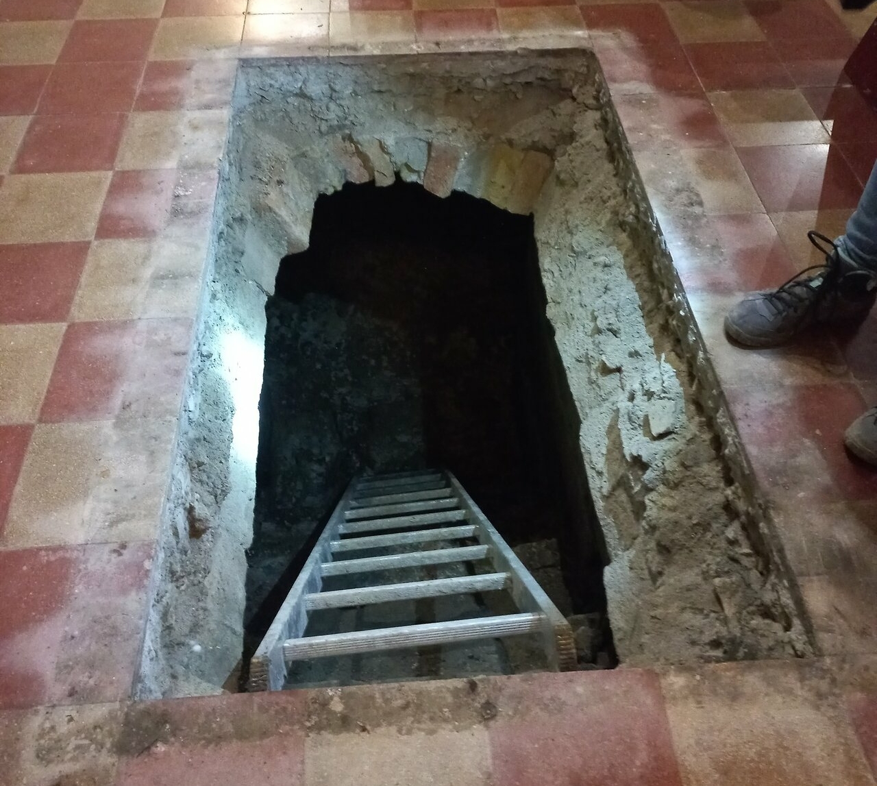 Museum archaeologists breaking open the entrance to the crypts